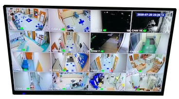 Security camera monitor showing different building rooms